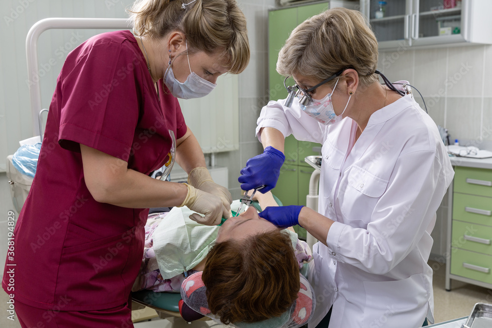 Doctor and nurse in the dental office. The patient receives treatment. Doctor and nurse in the dental office. The patient receives treatment.