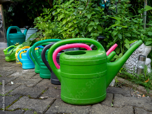 colorful watering can in garden © Animaflora PicsStock