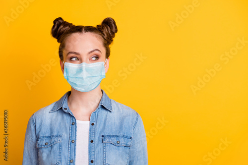 Close-up portrait of her she attractive curious funky minded brown-haired girl wearing safety mask looking aside thinking viral disease immunity care isolated bright vivid yellow color background