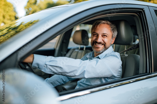 Man prepares to drive a car.