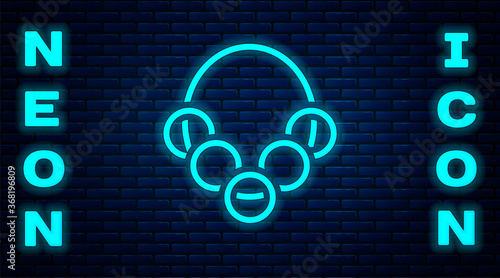 Glowing neon Russian bagels on a rope icon isolated on brick wall background. Vector.