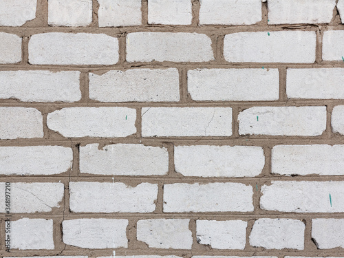 Brick wall, weathered, worn wall damaged paint. Grunge Concrete Surface. Great background or texture. photo