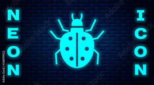 Glowing neon Mite icon isolated on brick wall background. Vector.