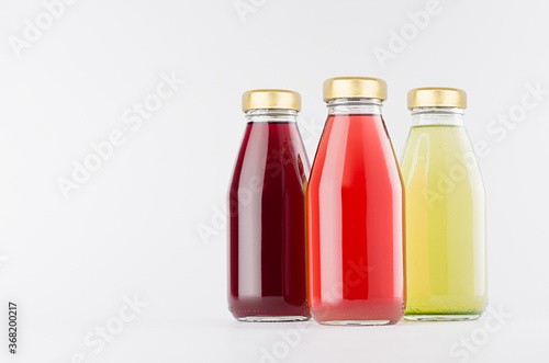 Red, pink, green fruit juices collection in glass bottles with cap mock up on white background, template for packaging, advertising, design product, branding.