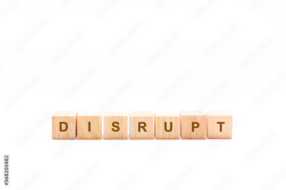DISRUPT word written in wooden cubes on a white background DISRUPT word written in wooden cubes on a white background