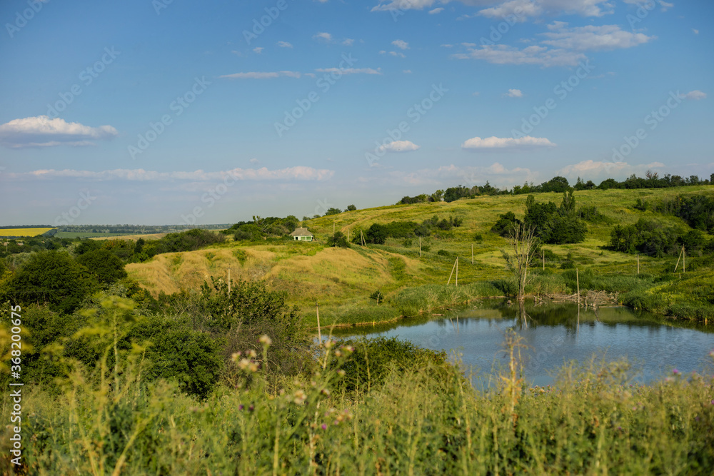 Village landscape with lake and blue sky
