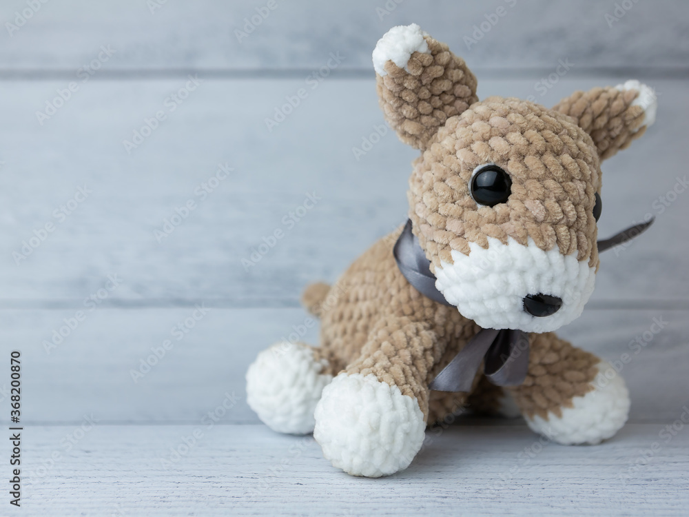 Plush dog on wooden background Plush dog on wooden background