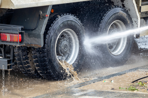 Washing truck wheels off dirt