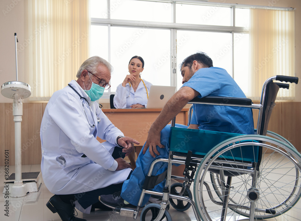 Caring doctor man caregiver support disabled elder men patient sit on wheelchair with doctor women at hospital, old doctor carer help paralyzed patient on wheelchair. health care, reanimation and medi Caring doctor man caregiver support disabled elder men patient sit on wheelchair with doctor women at hospital, old doctor carer help paralyzed patient on wheelchair. health care, reanimation and medi