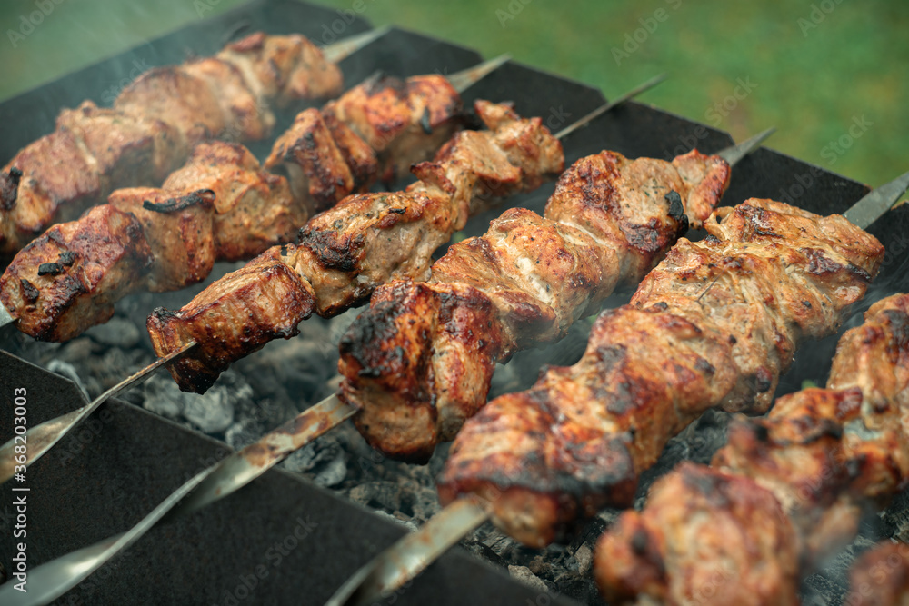 Shish kebab on skewers is fried on coals