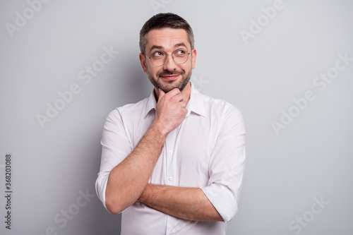Close-up portrait of his he nice attractive curious cheery mature man thinking creating new strategy development success isolated over light gray pastel color background
