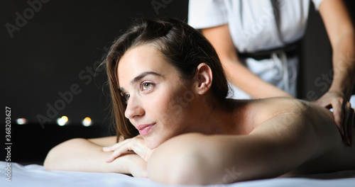 Young and healthy woman in spa salon. Traditional Swedish massage therapy