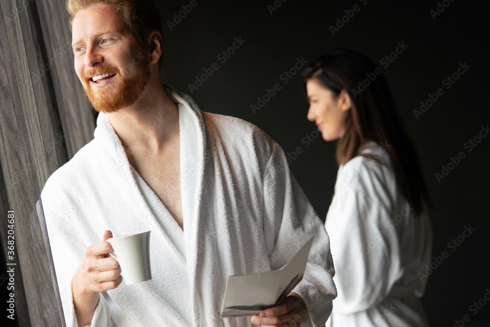 Young man in bathrobe drinking coffee at home Young man in bathrobe drinking coffee at home