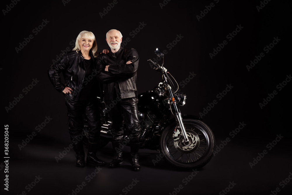 Portrait of his he her she nice attractive funky content cheerful cheery grey-haired couple chopper travelers club lifestyle freedom lovers folded arms isolated over black color background