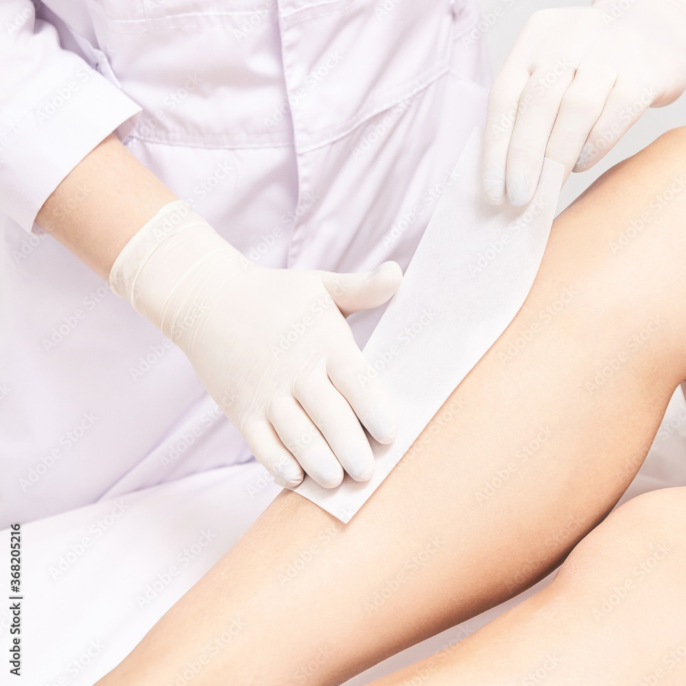 Hot hair removal depilation. Female skin routine. Sugar bodycare. Wax correction. Professional cosmetologist help girl. Sugaring bodycare cosmetics. Line correction Hot hair removal depilation. Female skin routine. Sugar bodycare. Wax correction. Professional cosmetologist help girl. Sugaring bodycare cosmetics. Line correction