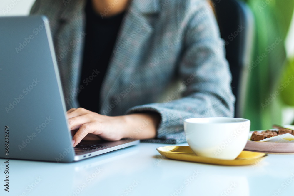 Closeup image of a business woman using and working on laptop computer in office Closeup image of a business woman using and working on laptop computer in office