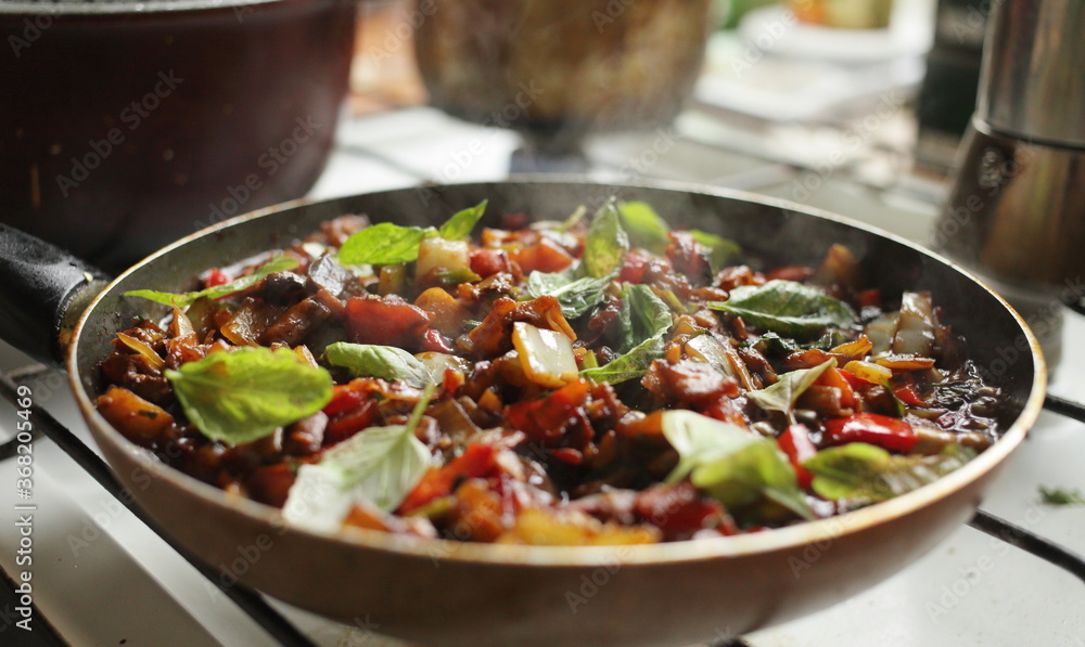 Healthy food vegetables are fried in a pan Tomato eggplant onion pepper zucchini Healthy food vegetables are fried in a pan Tomato eggplant onion pepper zucchini