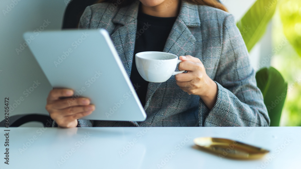 Closeup image of a business woman using digital tablet in office Closeup image of a business woman using digital tablet in office