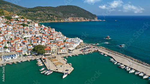 Aerial drone photo of beautiful main town and port of Skopelos island featuring landmark church of Virgin Mary and uphill venetian castle  Sporades islands  Greece