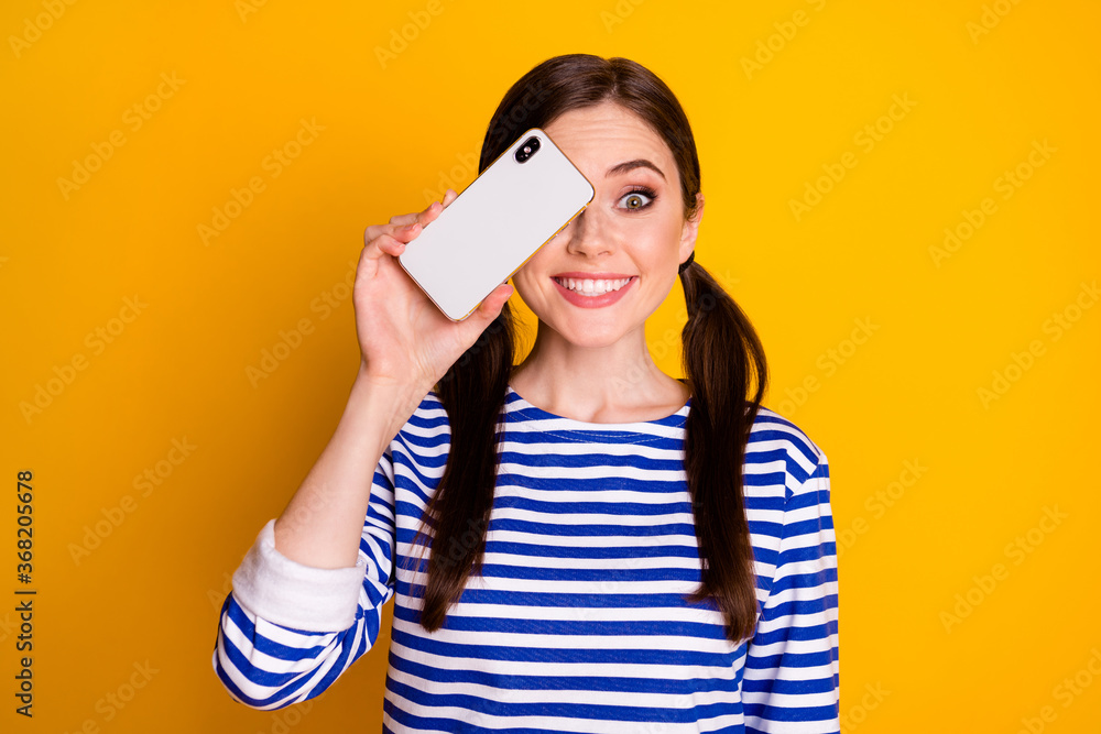 Portrait of candid crazy girl close cover eye smartphone look good isolated over vivid color background Portrait of candid crazy girl close cover eye smartphone look good isolated over vivid color background