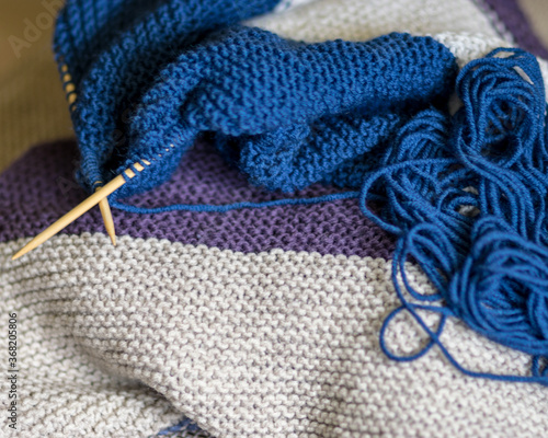 knitted sweater, knitting needles and yarn, close-up view