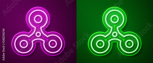 Glowing neon line Fidget spinner icon isolated on purple and green background. Stress relieving toy. Trendy hand spinner. Vector.