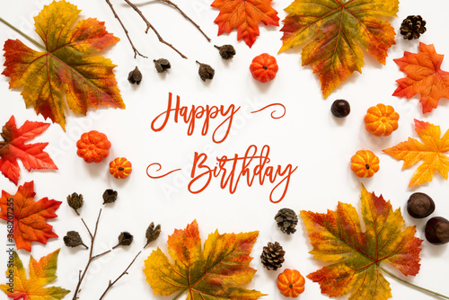 Beautiful Calligraphy Of English Text Happy Birthday. Frame Of Bright Colorful Autumn Leaf Decoration. photo