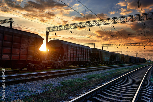railway and rail cars in a beautiful sunset, dramatic sky and sunlight