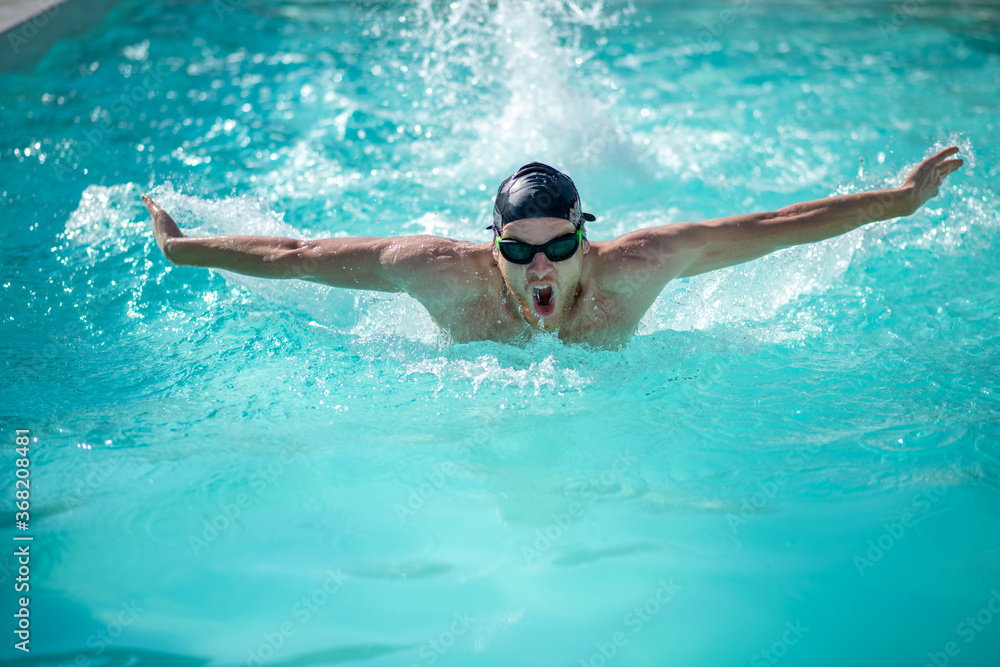 Swimmer on chest, hands to sides, mouth is open
