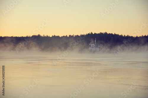 The tug sailing in the fog early in the morning.