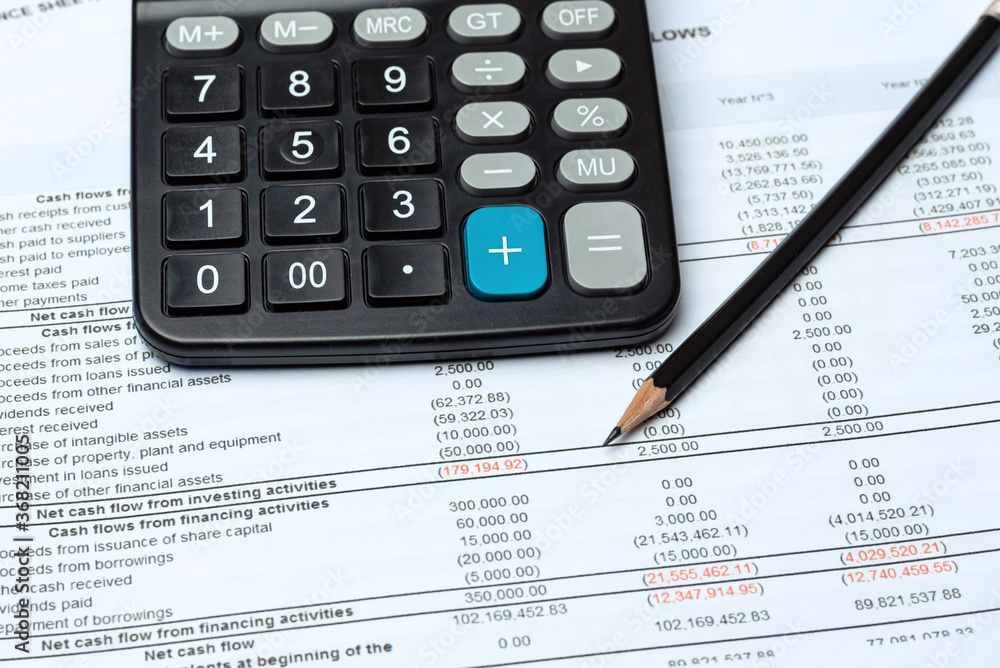 Pencil And Calculator On Financial Report - Business Accounting Concept Pencil And Calculator On Financial Report - Business Accounting Concept