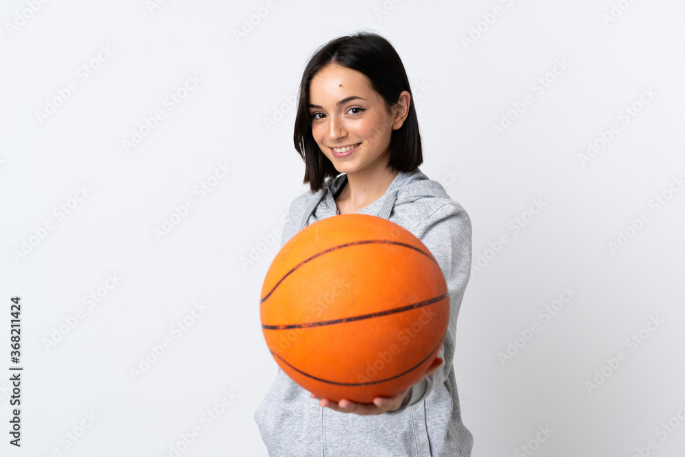 Young caucasian woman isolated on white background playing basketball