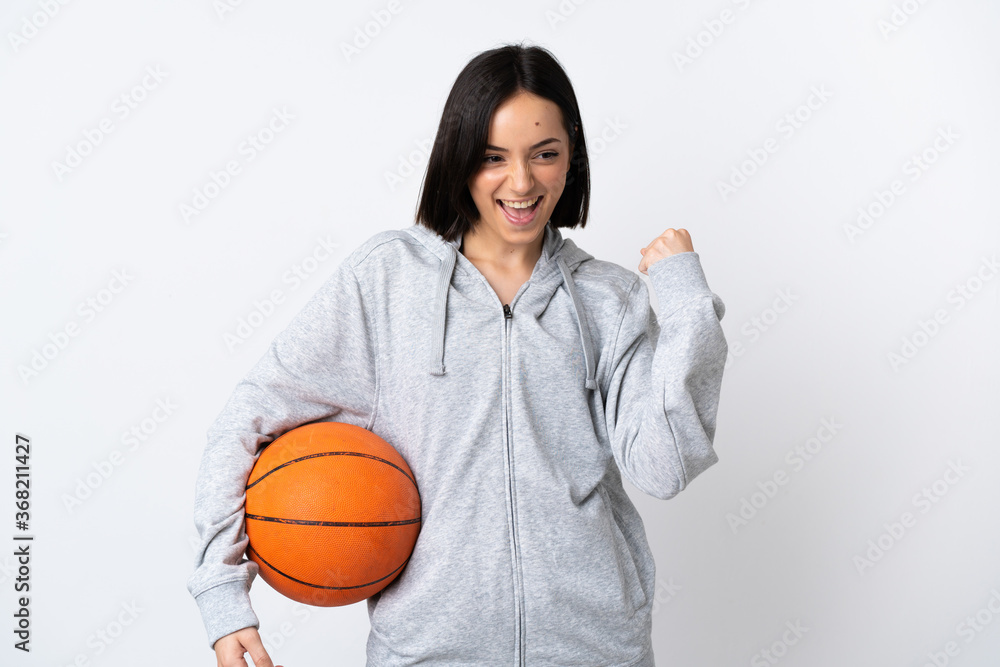 Young caucasian woman isolated on white background playing basketball Young caucasian woman isolated on white background playing basketball