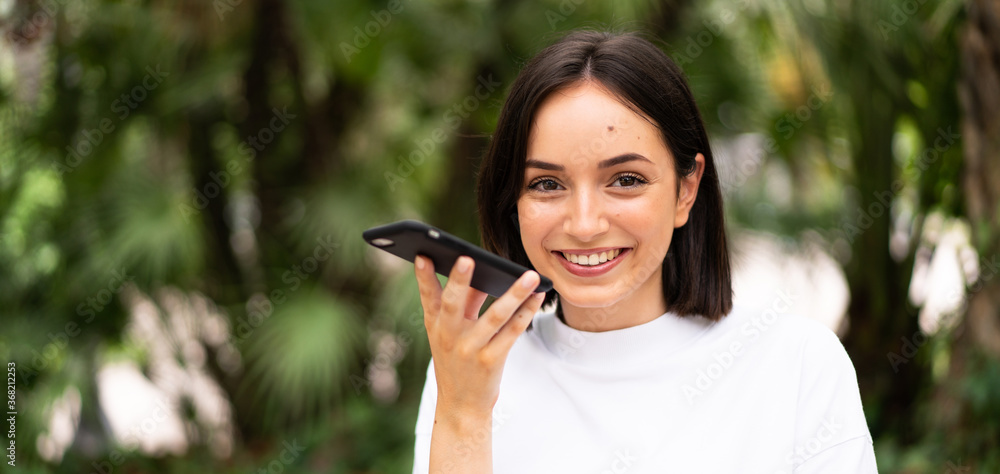 Young caucasian woman using a phone at outdoors Young caucasian woman using a phone at outdoors