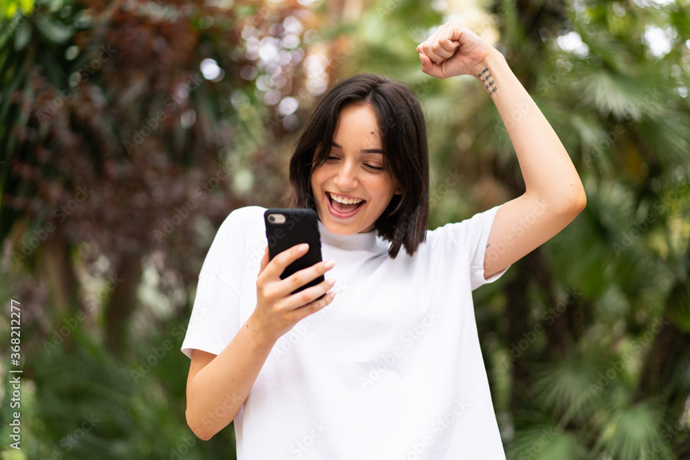 Young caucasian woman using a phone at outdoors Young caucasian woman using a phone at outdoors