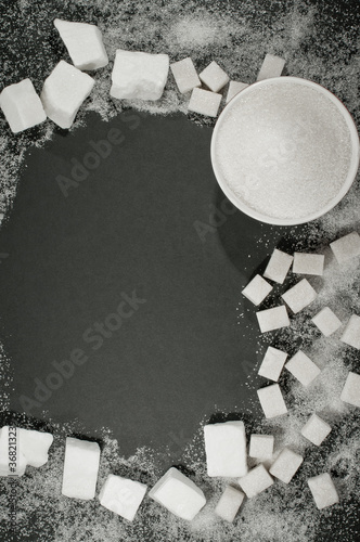 lump, cubes and granulated sugar on a black background. a source of carbohydrates glucose and sucrose