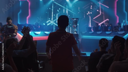 Wallpaper Mural Esport Professional Gamer Enters Video Game Championship Arena. Cyber Games Tournament Event with Crowd of Fans and Spectators Cheering for Favourite Players. Online Streaming Entertainment Torontodigital.ca