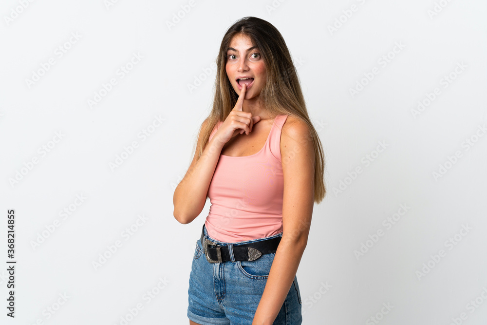 Young caucasian woman isolated on white background showing a sign of silence gesture putting finger in mouth Young caucasian woman isolated on white background showing a sign of silence gesture putting finger in mouth