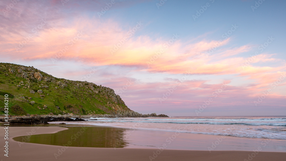 A pastel sunset with water reflections on the beach at Petrel Cove located on the Fleurieu Peninsula Victor Harbor South Australia on July 28 2020 A pastel sunset with water reflections on the beach at Petrel Cove located on the Fleurieu Peninsula Victor Harbor South Australia on July 28 2020