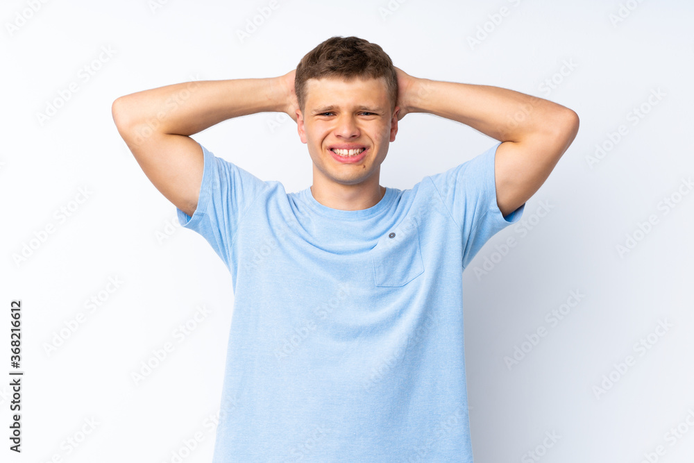 Young handsome man over isolated white background frustrated and takes hands on head