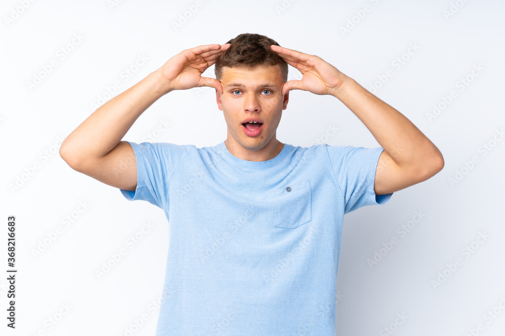 Young handsome man over isolated white background with surprise expression Young handsome man over isolated white background with surprise expression