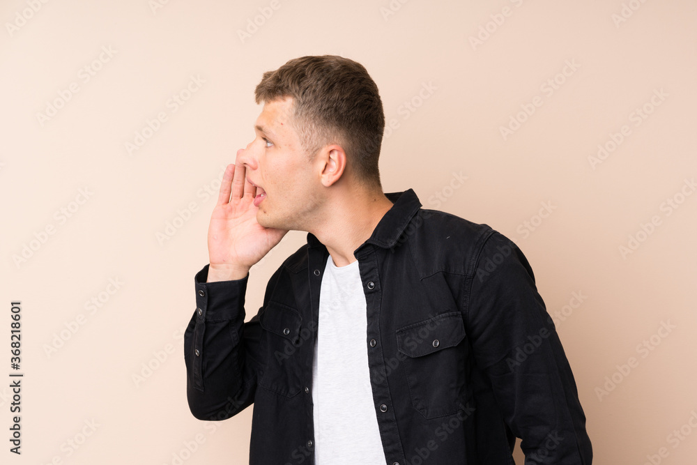 Young handsome man shouting with mouth wide open Young handsome man shouting with mouth wide open