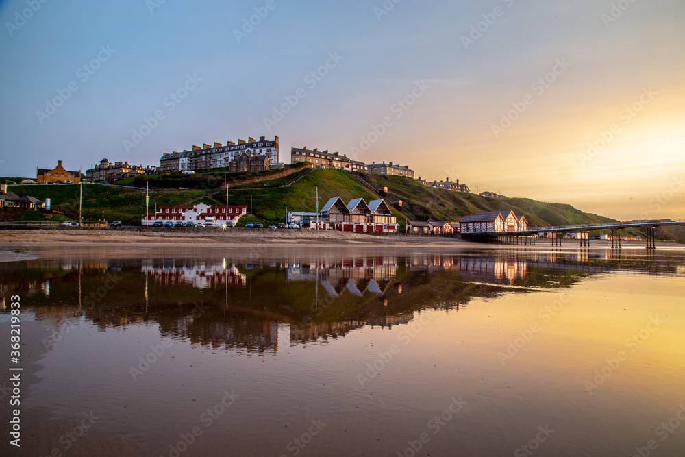 Seaside town reflected in wet sand