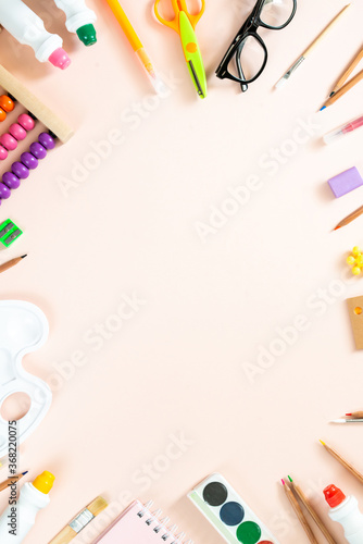 School supplies on pink background. Back to school concept. Frame, flatlay, copy space for text