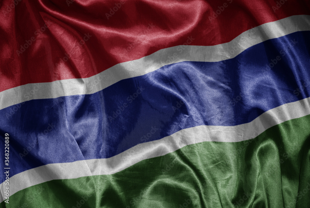colorful shining big national flag of gambia on a silky texture