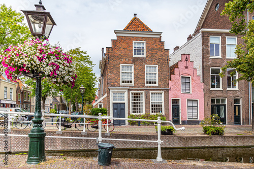 Cityscape Leiden street view with typical Dutch gable houses and canal in the old city centrer of Leiden in the Netherlands photo