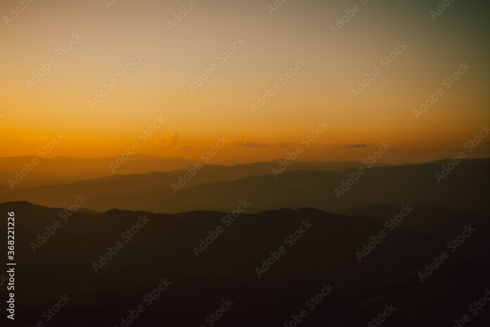 Obraz premium View of silhouatte of mountain range under the sky during the sunset. Beautiful evening nature background.