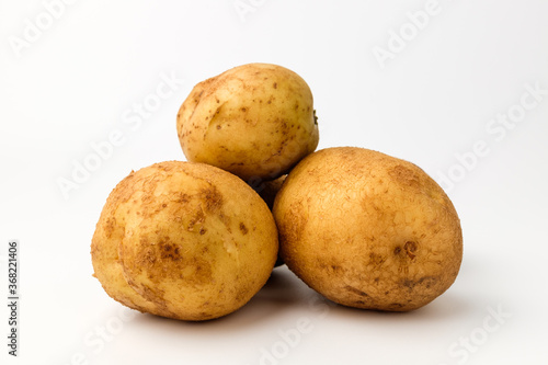 Raw potatoes on a white background