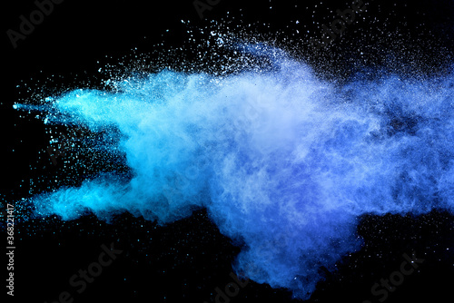 Fototapeta Naklejka Na Ścianę i Meble -  Closeup of blue dust particle splash isolated on black background.