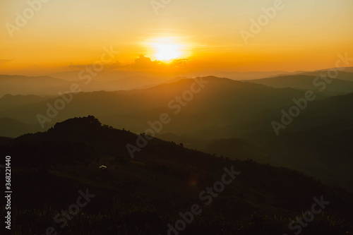 View of silhouatte of mountain range under the sky during the sunset. Beautiful evening nature background.